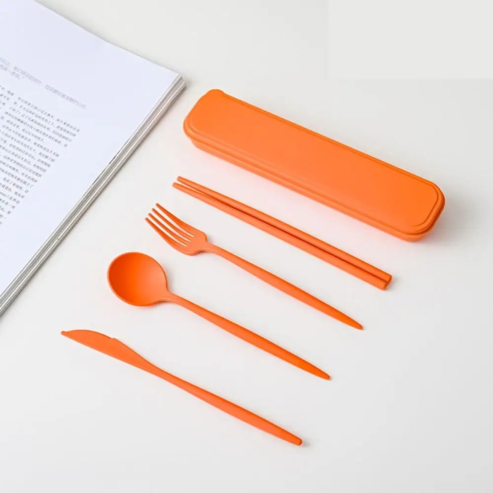 Orange kawaii utensils set with case on a white surface