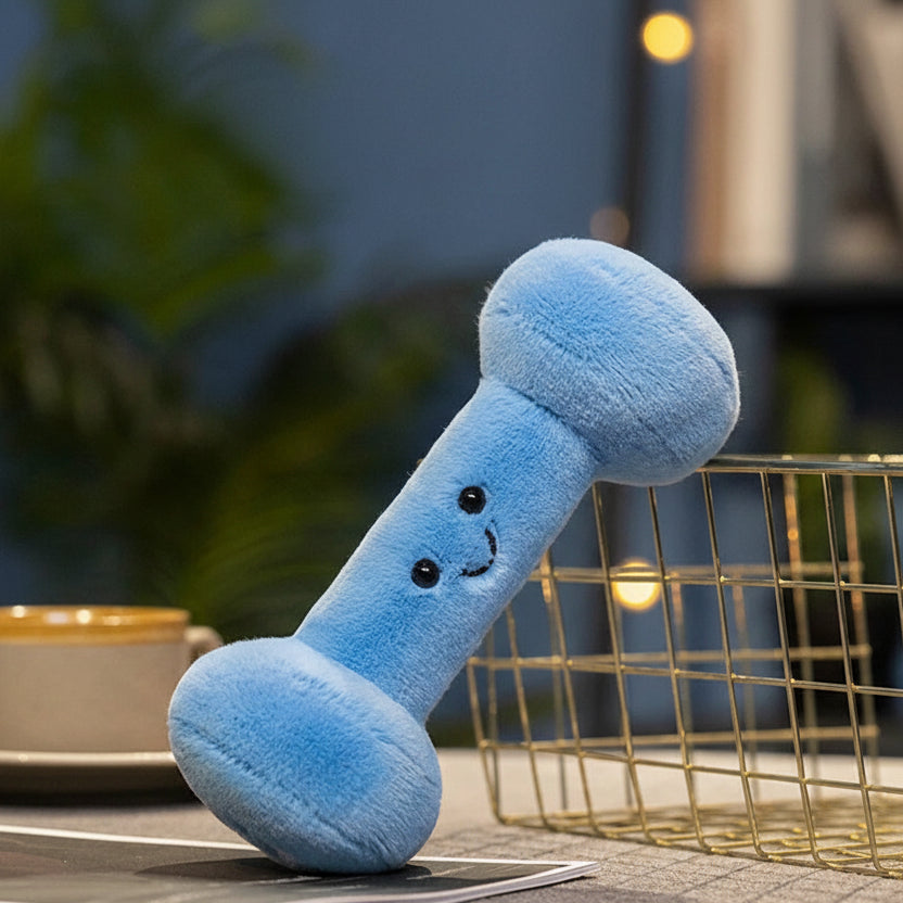 Blue kawaii plush dog toy shaped like a bone with a smiley face on a blurred background