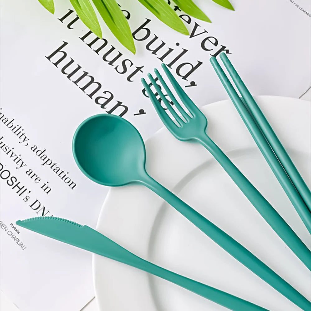 A set of green kawaii utensils with fork, spoon, knife and chopsticks