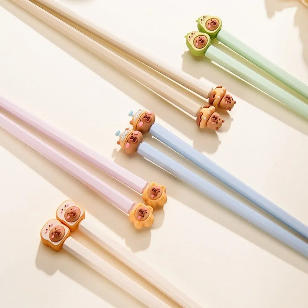 Colorful kawaii chopsticks with decorative ends on a light background
