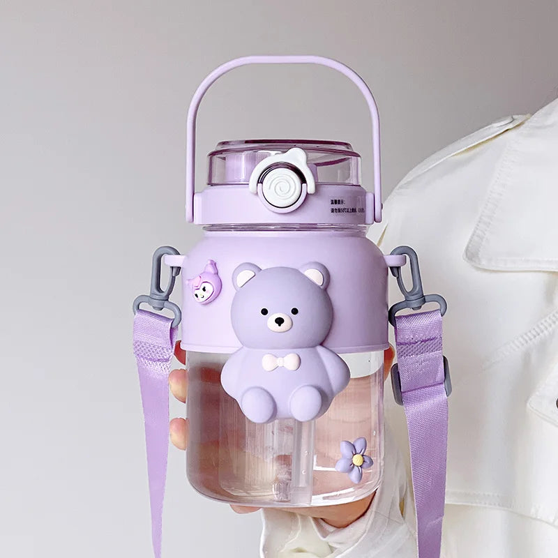 Purple bear-themed kawaii water bottle with a strap held by a person against a neutral background