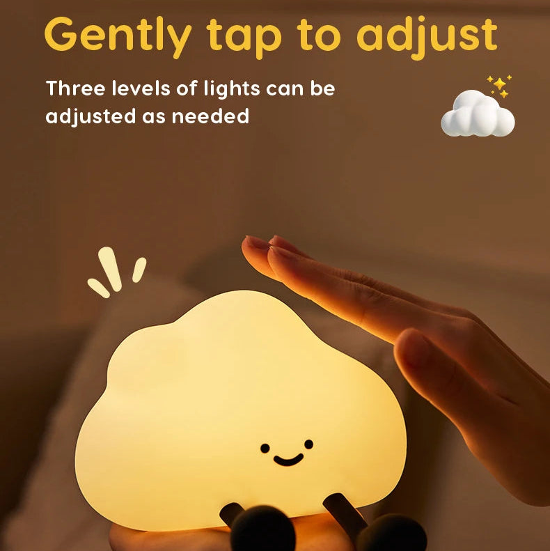 Silicone kawaii night light with a hand adjusting the light levels on a brown background