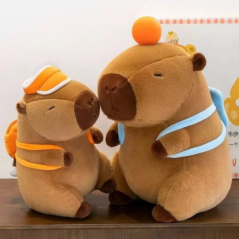 Two brown kawaii plush toys with orange and blue accents on a wooden surface.