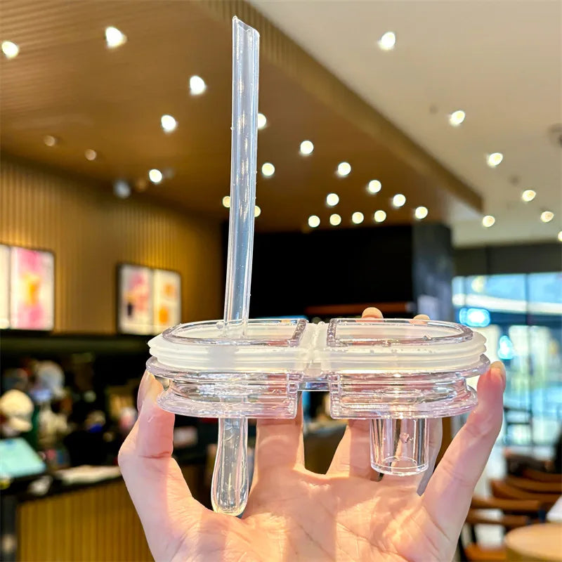 Kawaii themed clear plastic lid with a straw held by a hand in an indoor setting
