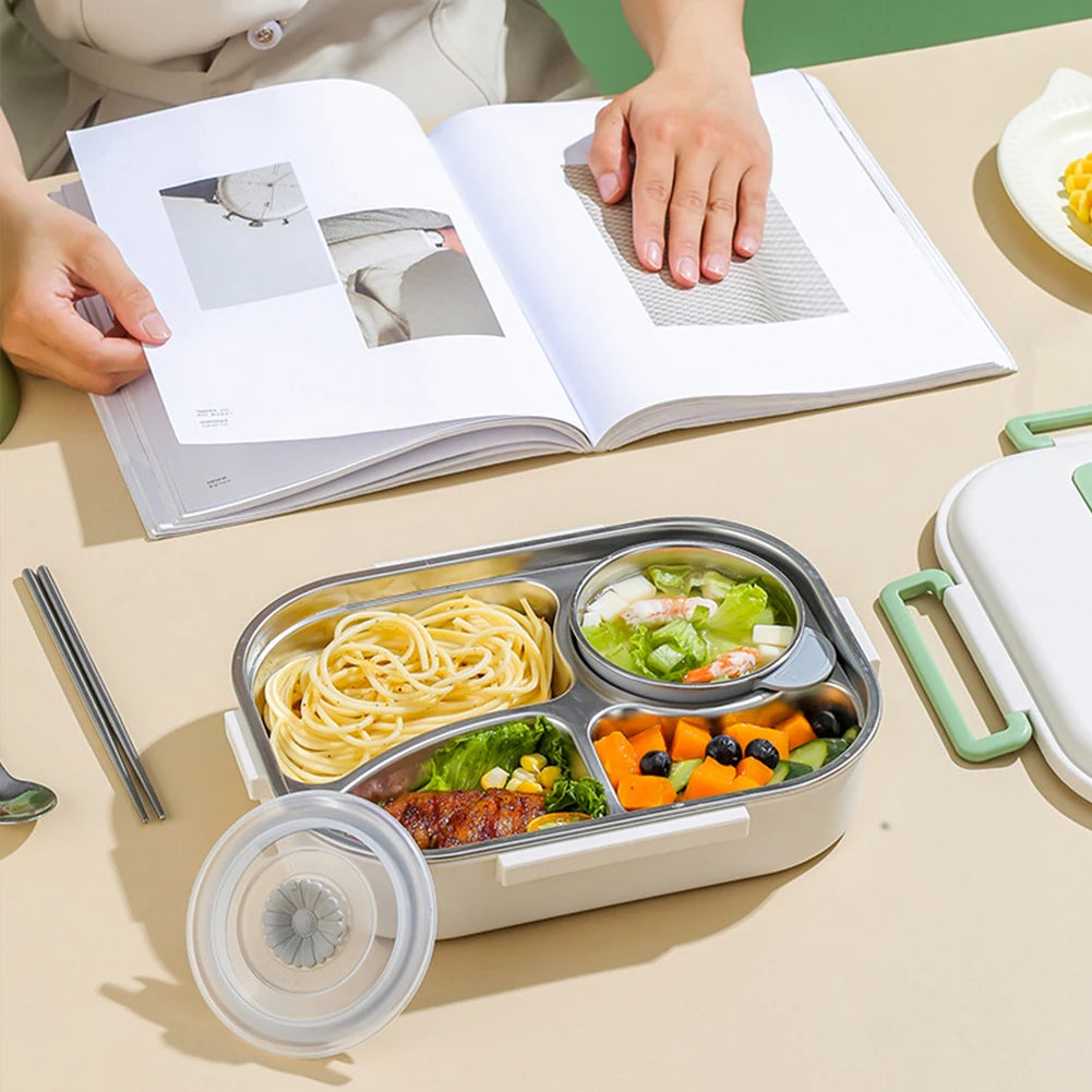 Kawaii bento box with compartments of food on a table next to an open book