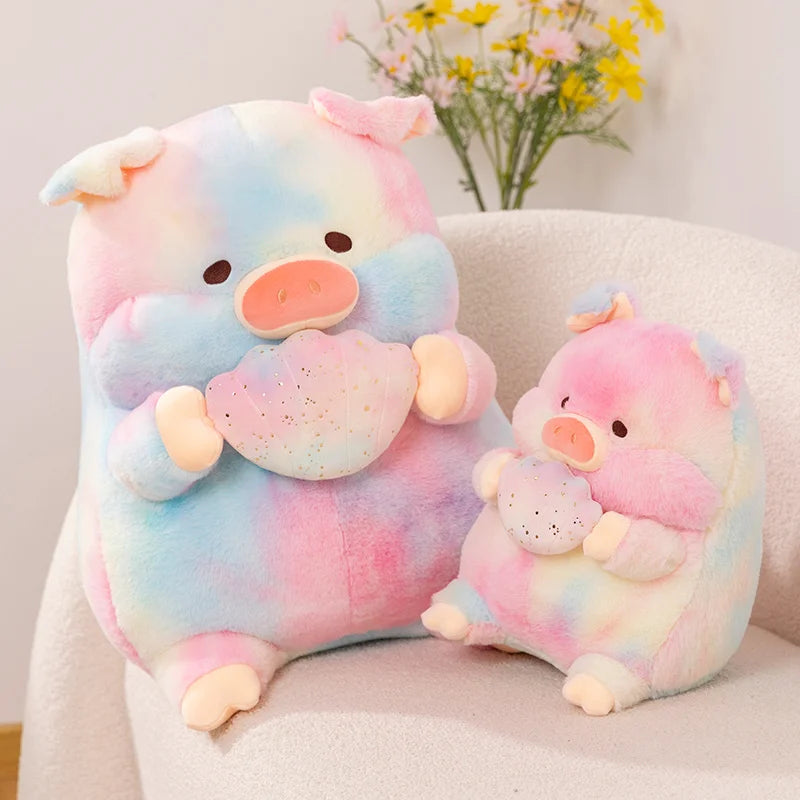 Two rainbow kawaii pig plush toys sitting on a chair holding a shell