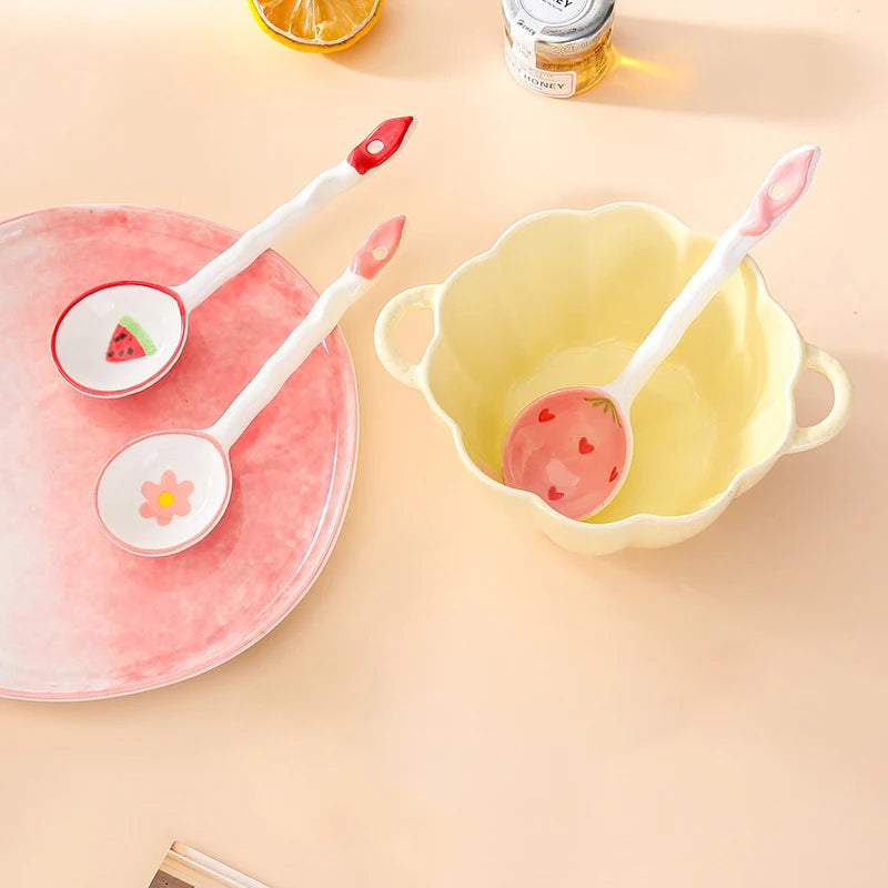 Three white and pink kawaii spoons on a dinner plate