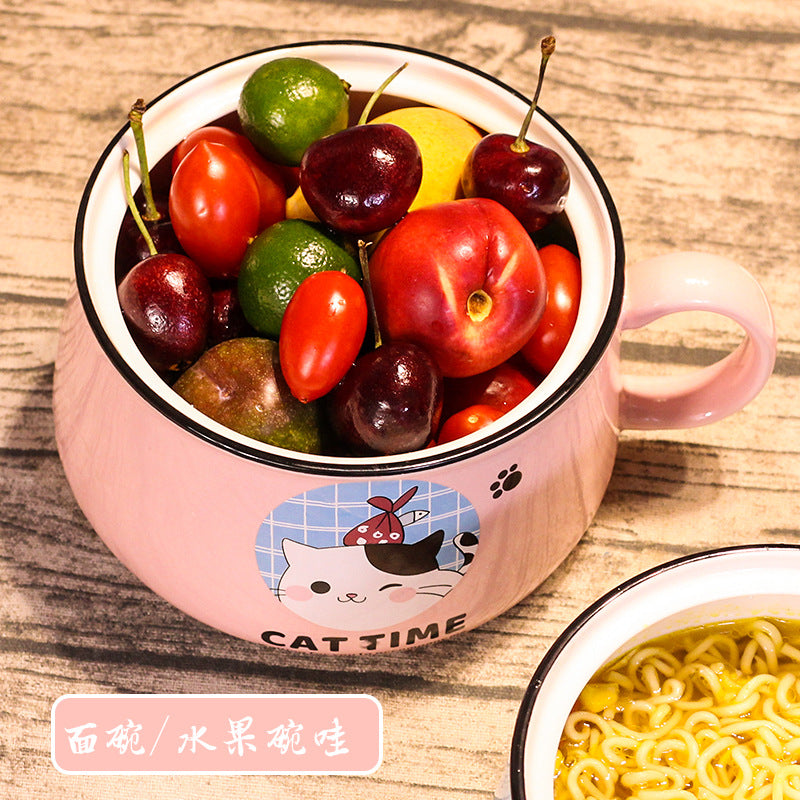 A pink cat themed kawaii ramen bowl with fruit in it