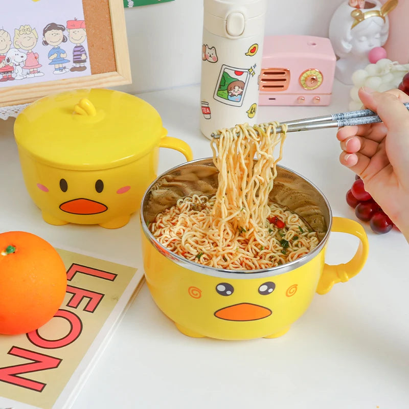Someone eating noodles out of a duck themed kawaii ramen bowl