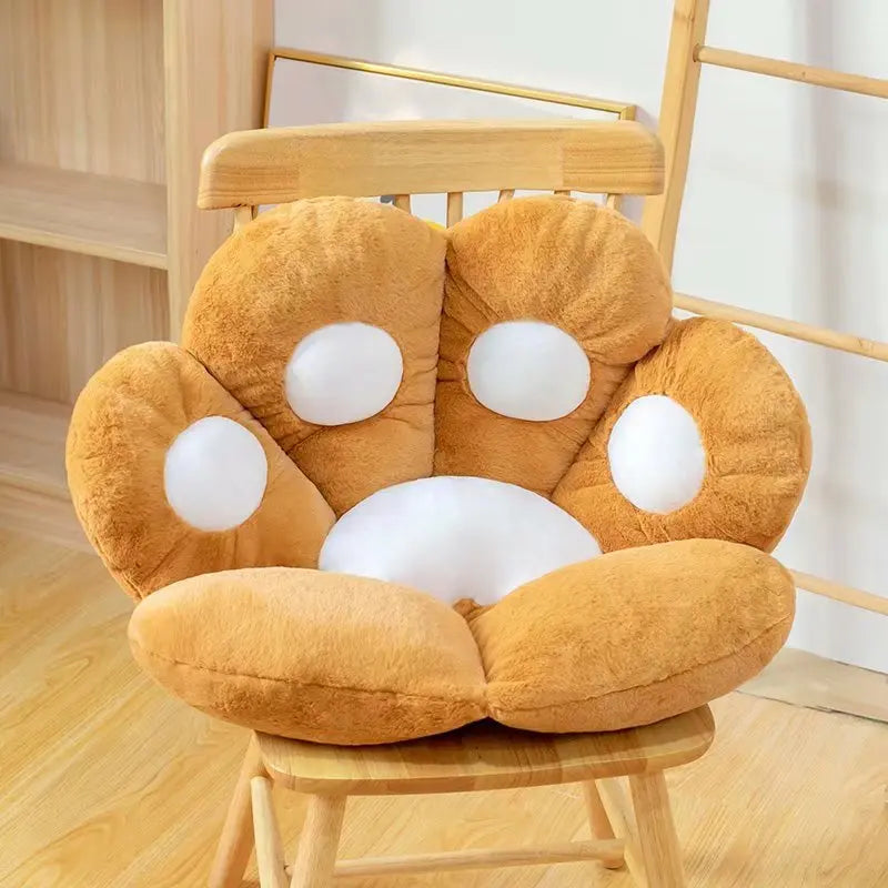 Fluffy brown kawaii cushion with white circles on a wooden chair