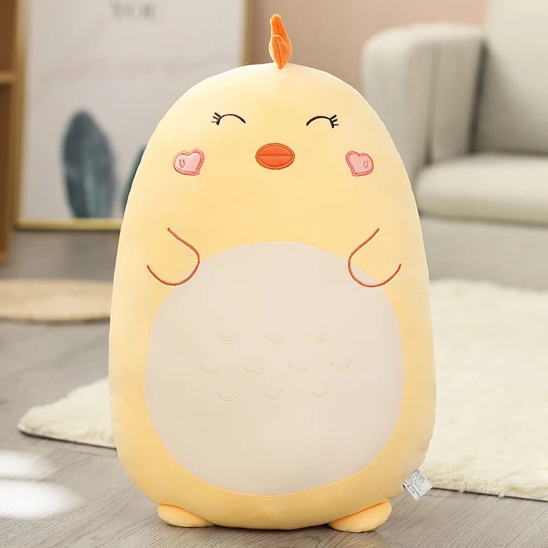 Plush kawaii toy chick pillow on a wooden floor with a neutral background