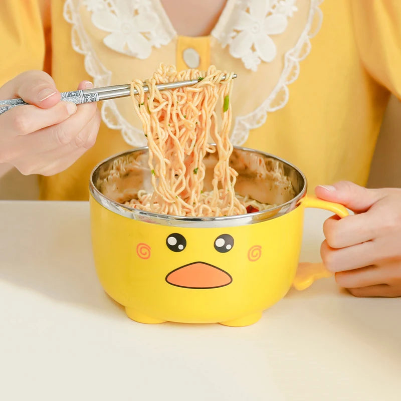A person eating noodles out of a duck themed kawaii ramen bowl