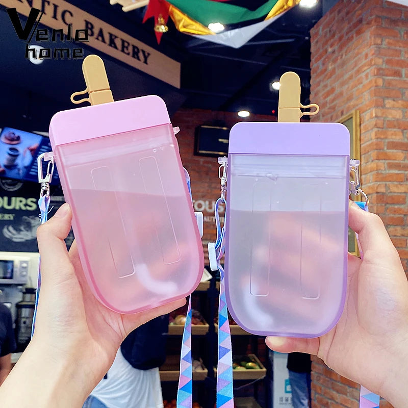 Pink and purple ice cream-themed kawaii water bottle held in front of a bakery.
