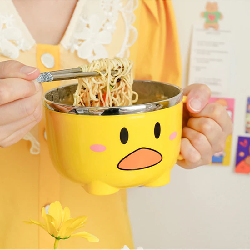 A woman eating noodles out of a duck themed kawaii ramen bowl
