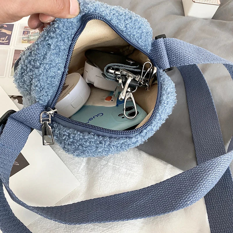 Blue textured Kawaii-style pouch with a hand holding it open, revealing items inside.