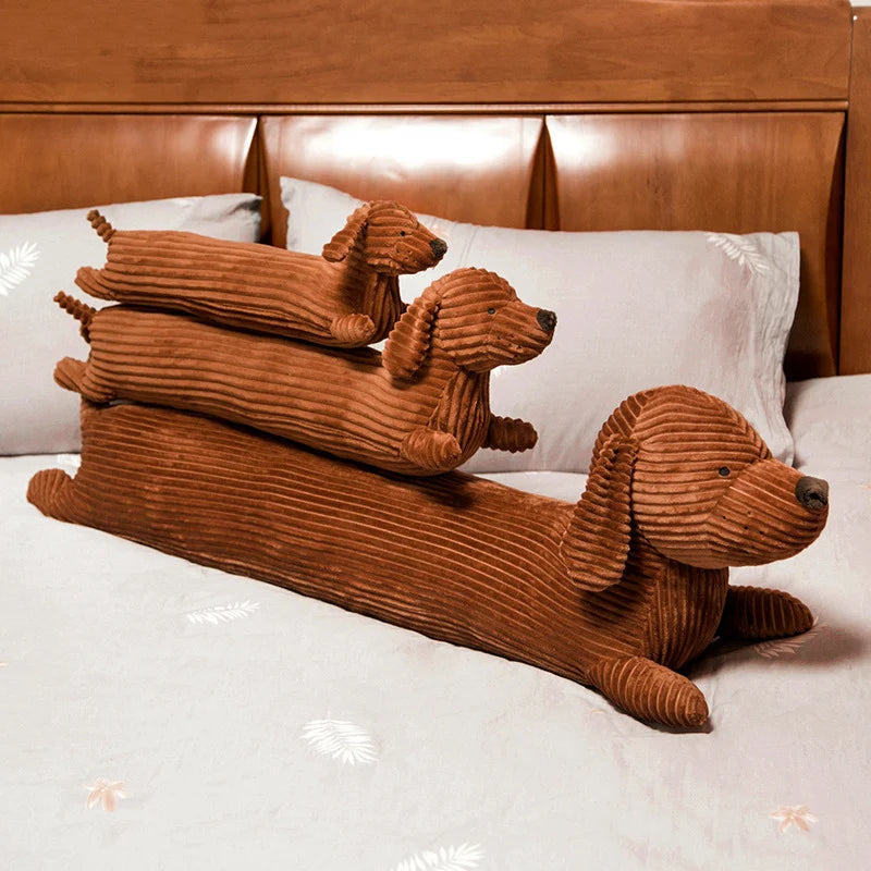 Three brown dog-shaped kawaii pillows on a bed with a wooden headboard.