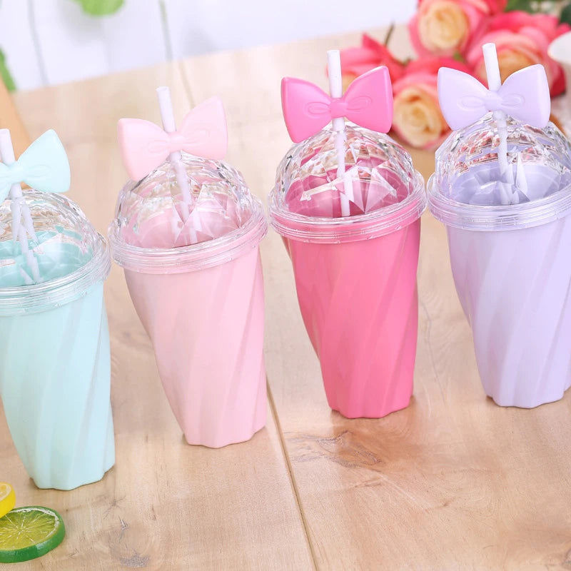 Set of colorful kawaii cups with animal ear lids on a wooden surface.