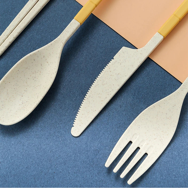 Set of kawaii utensils with yellow handles on a blue and peach background