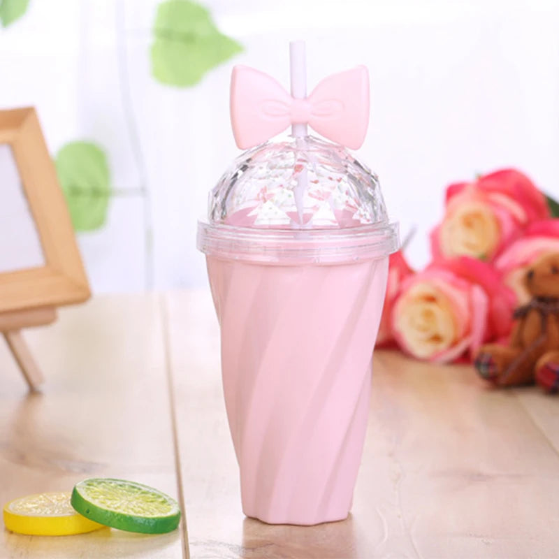 Pink kawaii cup with a bow on top, surrounded by flowers and a teddy bear