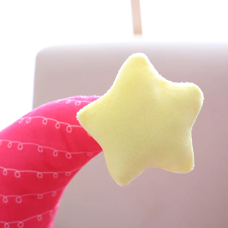 Yellow kawaii star-shaped plush toy on a pink fabric background