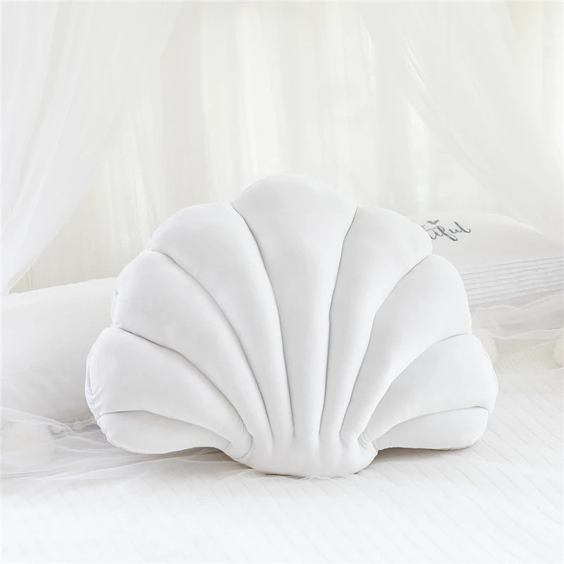 White shell-shaped kawaii pillow on a white background
