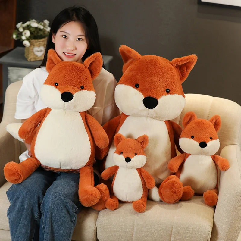Woman sitting on a couch with four fox-themed kawaii plush toys of different sizes.