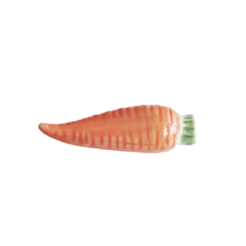 Carrot-shaped kawaii chopstick holders on a white background