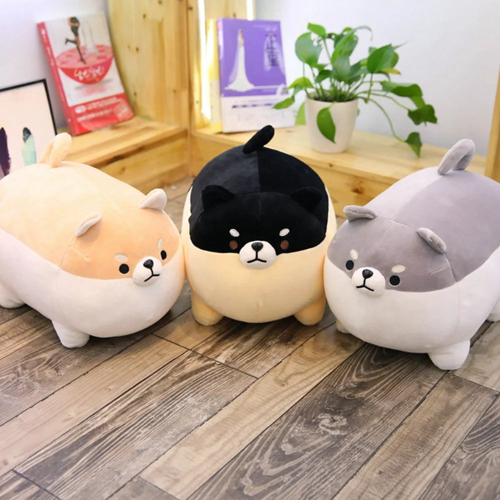Three kawaii plush toys resembling animals on a wooden floor.