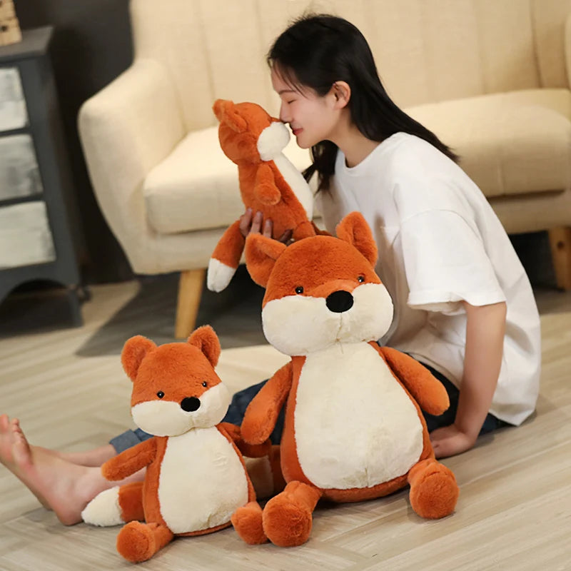 Woman playing with kawaii plush fox toys on a wooden floor.
