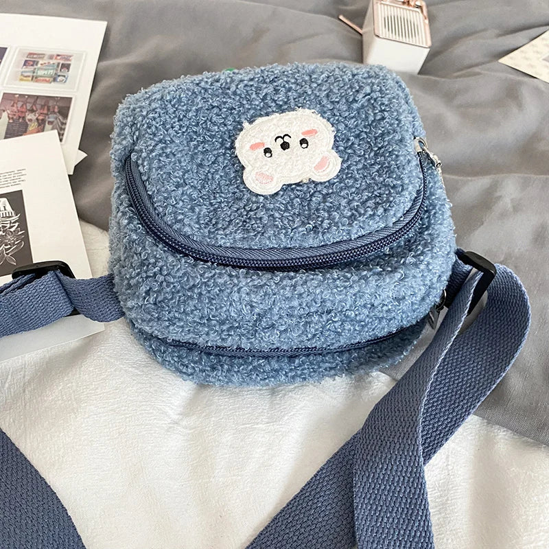 Blue fleece pouch with a Kawaii cloud design on a textured surface
