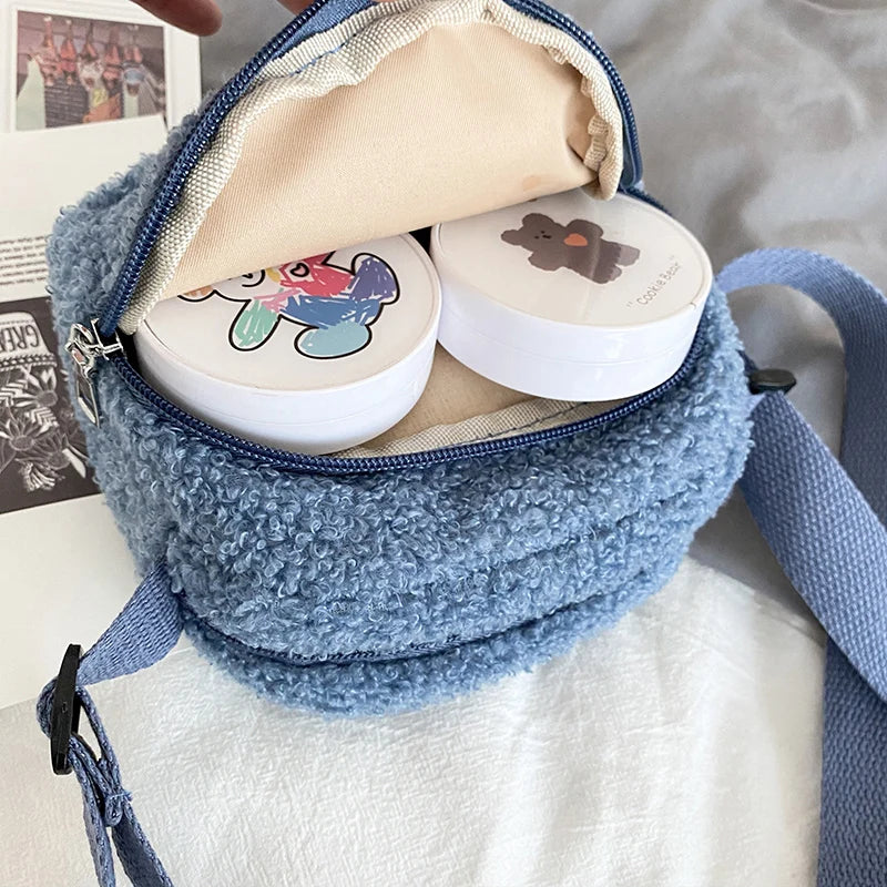 Blue textured bag with two round containers featuring Kawaii cartoon characters on a white surface.