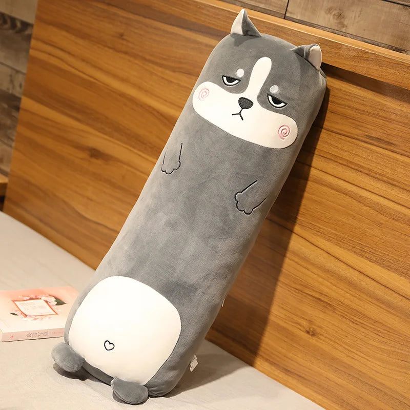 Kawaii plush toy shaped like a dog with a sad expression on a wooden surface.