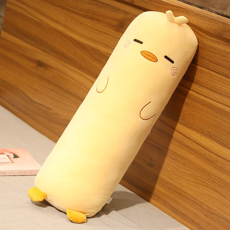 Yellow kawaii plush toy resembling a cartoon character on a wooden surface