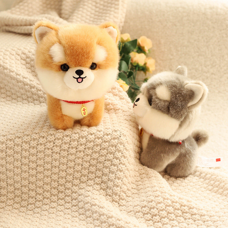 Two kawaii plush toys, one brown and white and one gray and white, on a textured surface with flowers in the background.