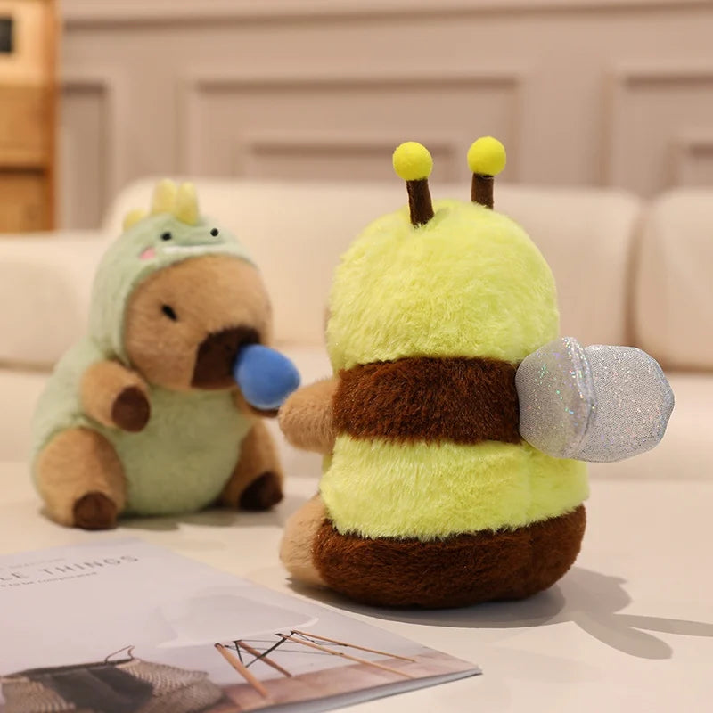 Two kawaii plush toys, one resembling a bee and the other a bear, on a light surface.