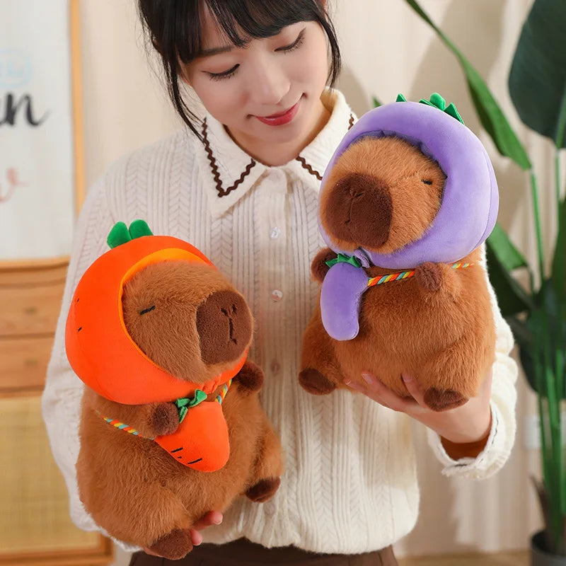 Person holding two kawaii plush toys resembling beavers in costumes.