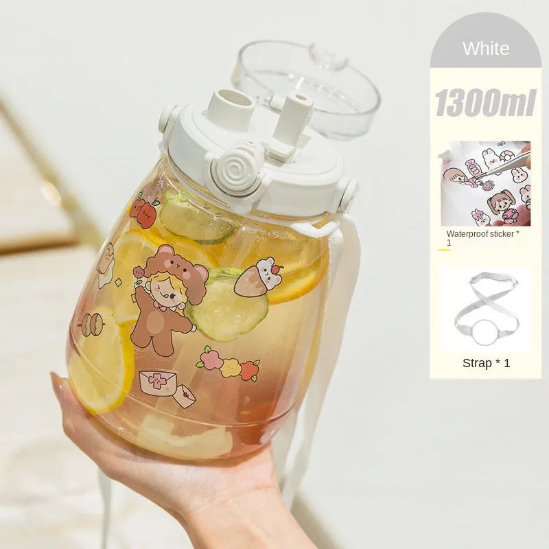 Clear kawaii water bottle with cartoon designs held by a hand, on a light background