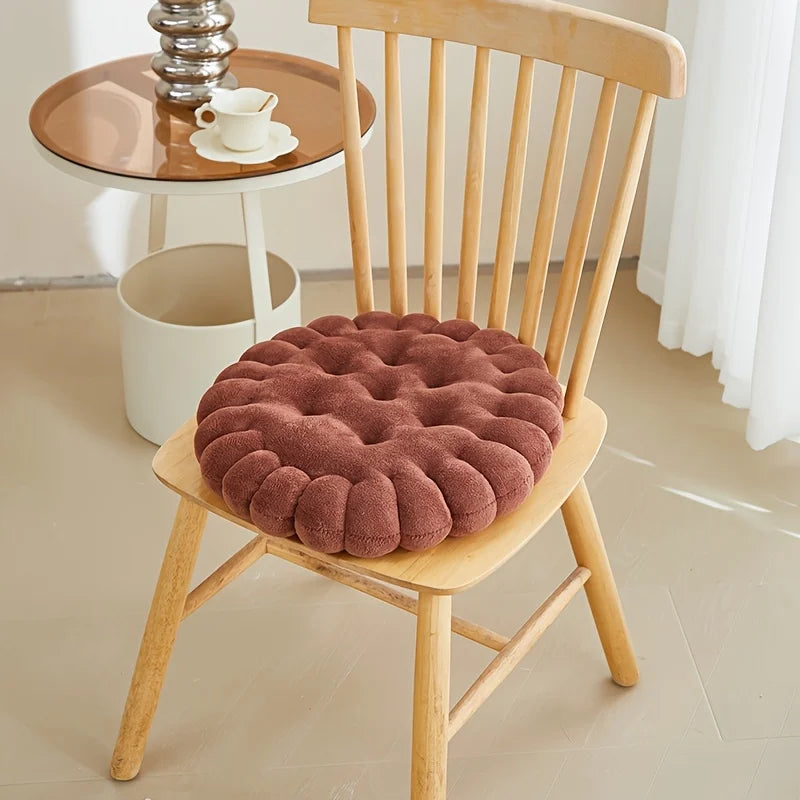 Brown kawaii cushion on a wooden chair with a blurred background