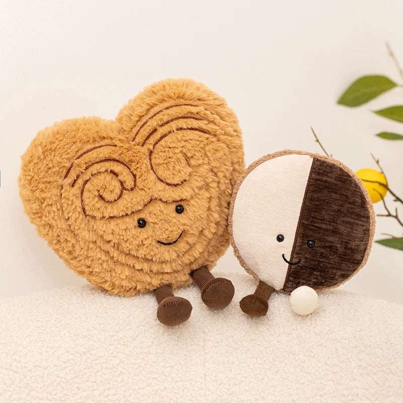 Two kawaii plush toys shaped like a heart and a half-circle on a light background