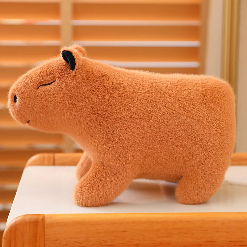 Kawaii plush toy capybara on a wooden surface with a blurred background