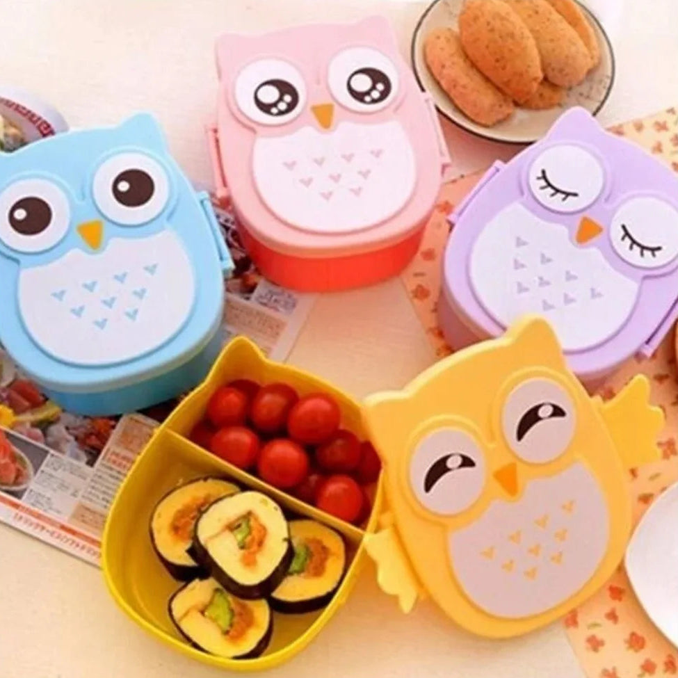 Set of colorful owl-shaped kawaii bento boxes with food on a table.