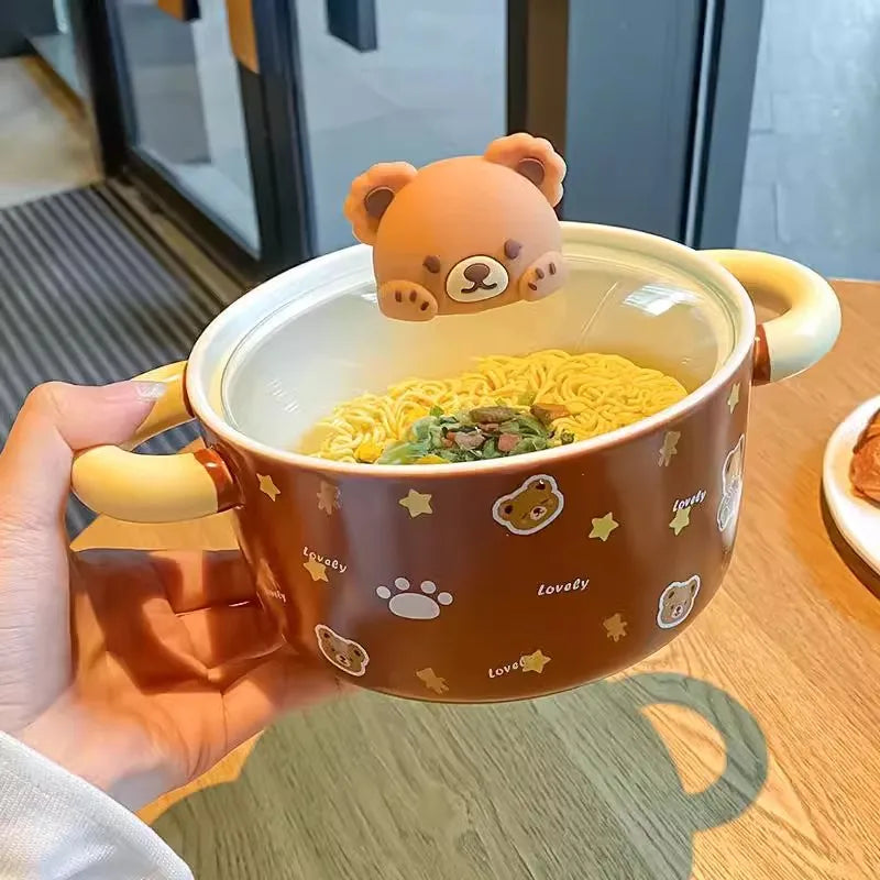 A hand holding a brown bear themed kawaii ramen bowl