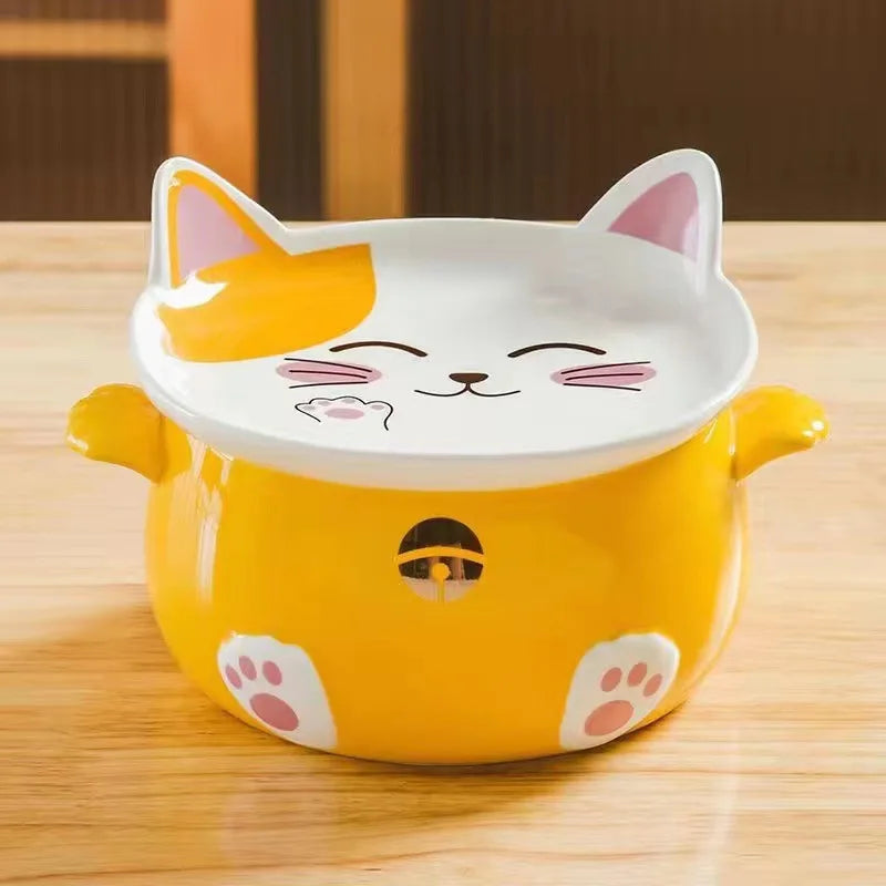 Yellow cat-shaped kawaii ramen bowl with a white lid on a wooden surface