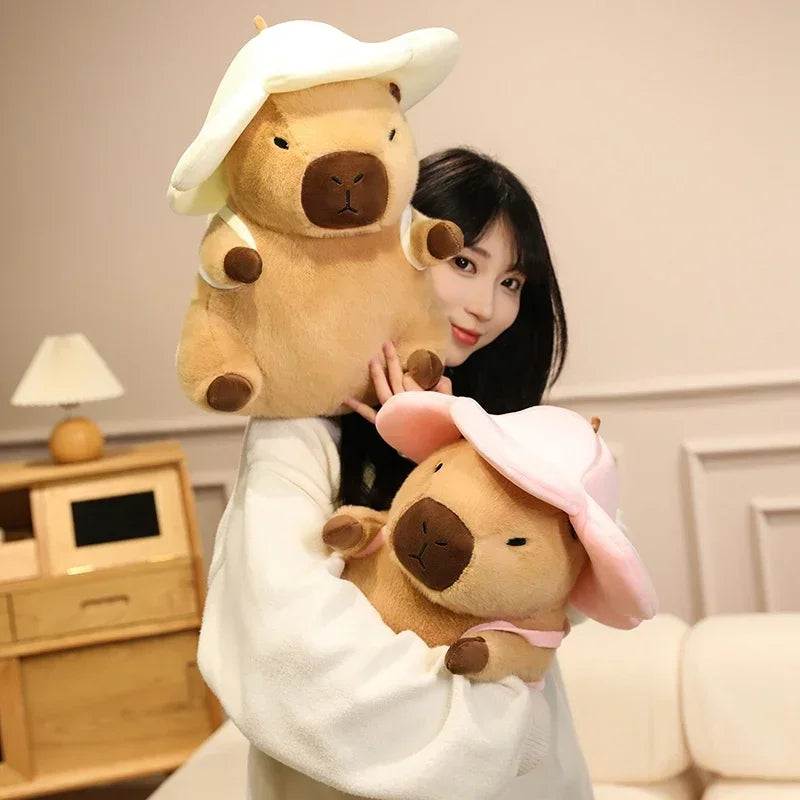 Person holding two large kawaii plush toys resembling bears with bunny ears in a room.