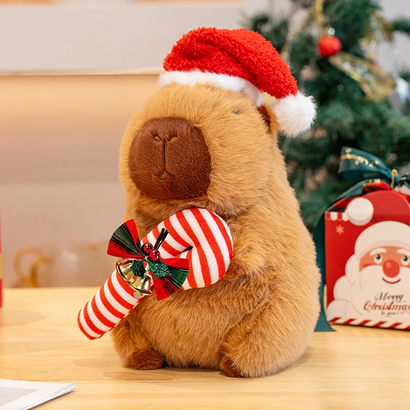 Kawaii plush bear wearing a Santa hat and striped stockings with a Christmas tree in the background
