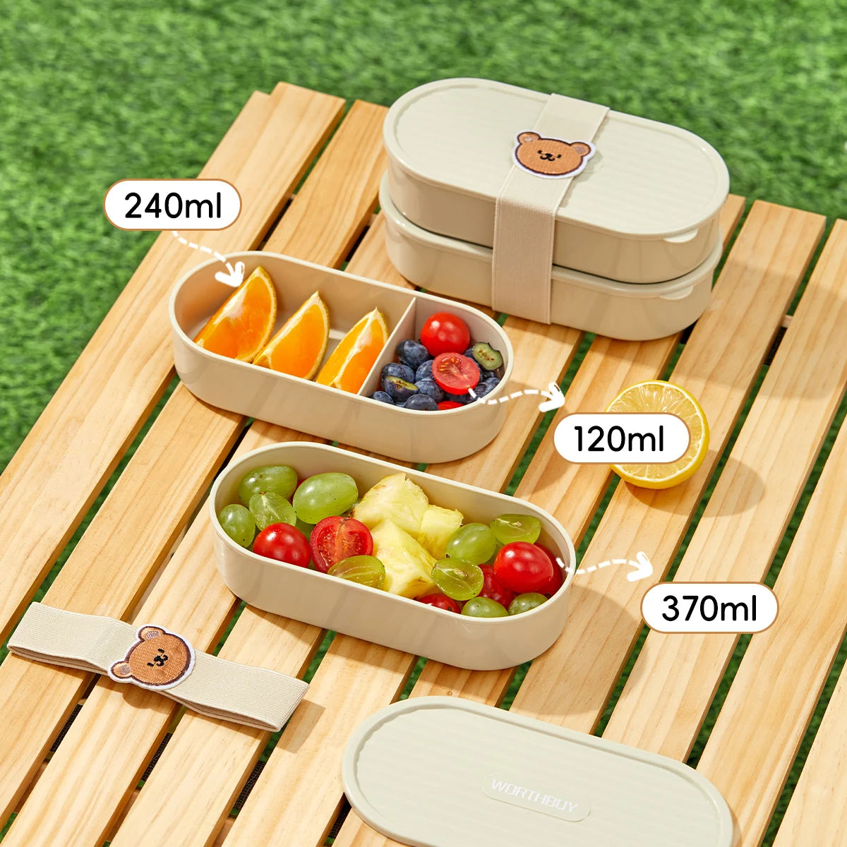 Two beige kawaii bento boxes with compartments filled with fruits on a wooden surface.
