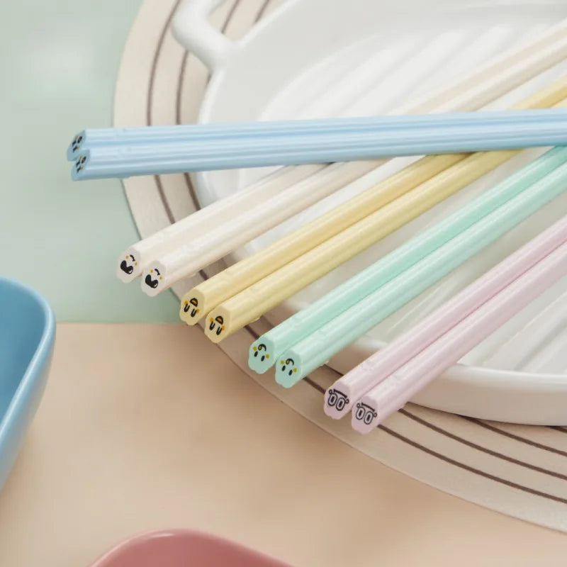 Set of colorful kawaii chopsticks on a neutral background