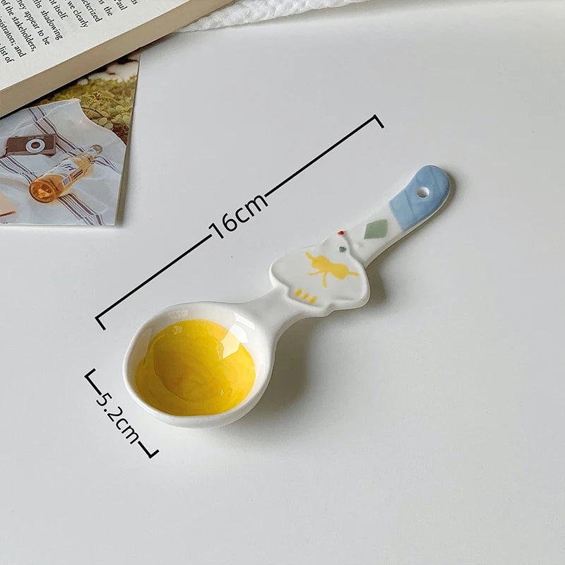 A white ceramic kawaii spoon on a table