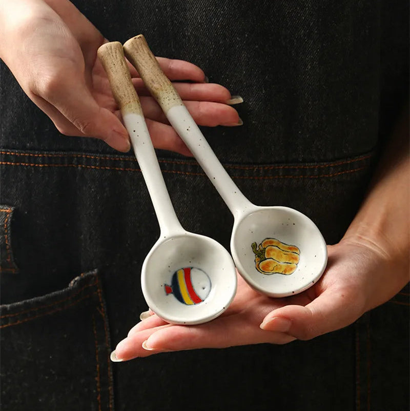 Someone holding two ceramic kawaii spoons