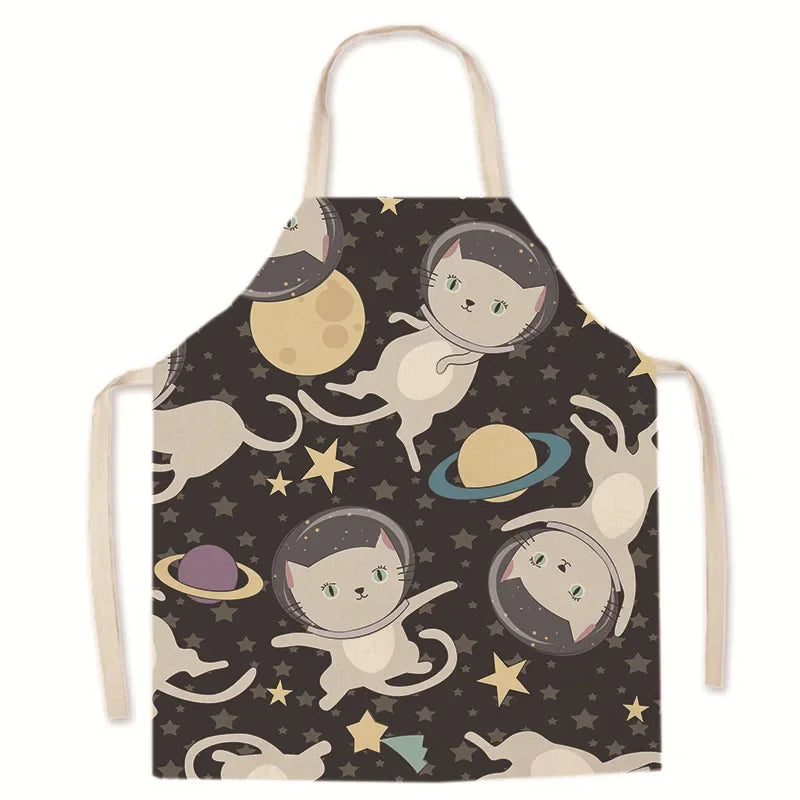 Kawaii apron with space-themed design featuring cats in astronaut hats and planets on a dark background.